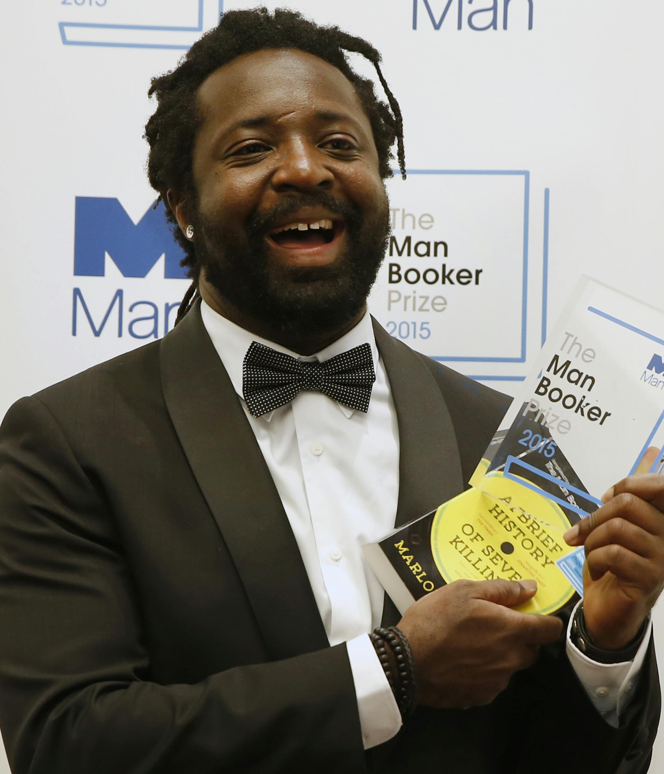 Jamaican author Marlon James holds the award after his book 'A Brief History of Seven Killings' was named as winner of the 2015 Booker Prize 2015 for Fiction, poses for photographers following the award ceremony at the Guildhall in London, Tuesday, Oct. 13, 2015. Marlon James became the first Jamaican winner of the prestigious Booker Prize for fiction Tuesday with a vivid, violent, exuberant and expletive-laden novel based on the 1976 attempted assassination of Bob Marley.(AP Photo/Alastair Gran