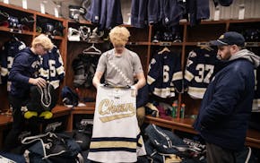 Goaltender Kam Hendrickson gets the folds just right as he and teammates packed Wednesday to leave Chanhassen High School for the state tournament.