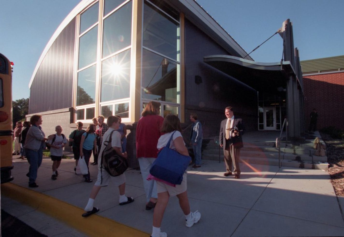 Greeting the students outside the new modern building on the first day of class is artistic director Dennis Jewitt ( blue blazer), as well as other teachers and staff. They were expecting 19 buses bringing stuidenst from as far as Richfield, but there were some transportation glitches