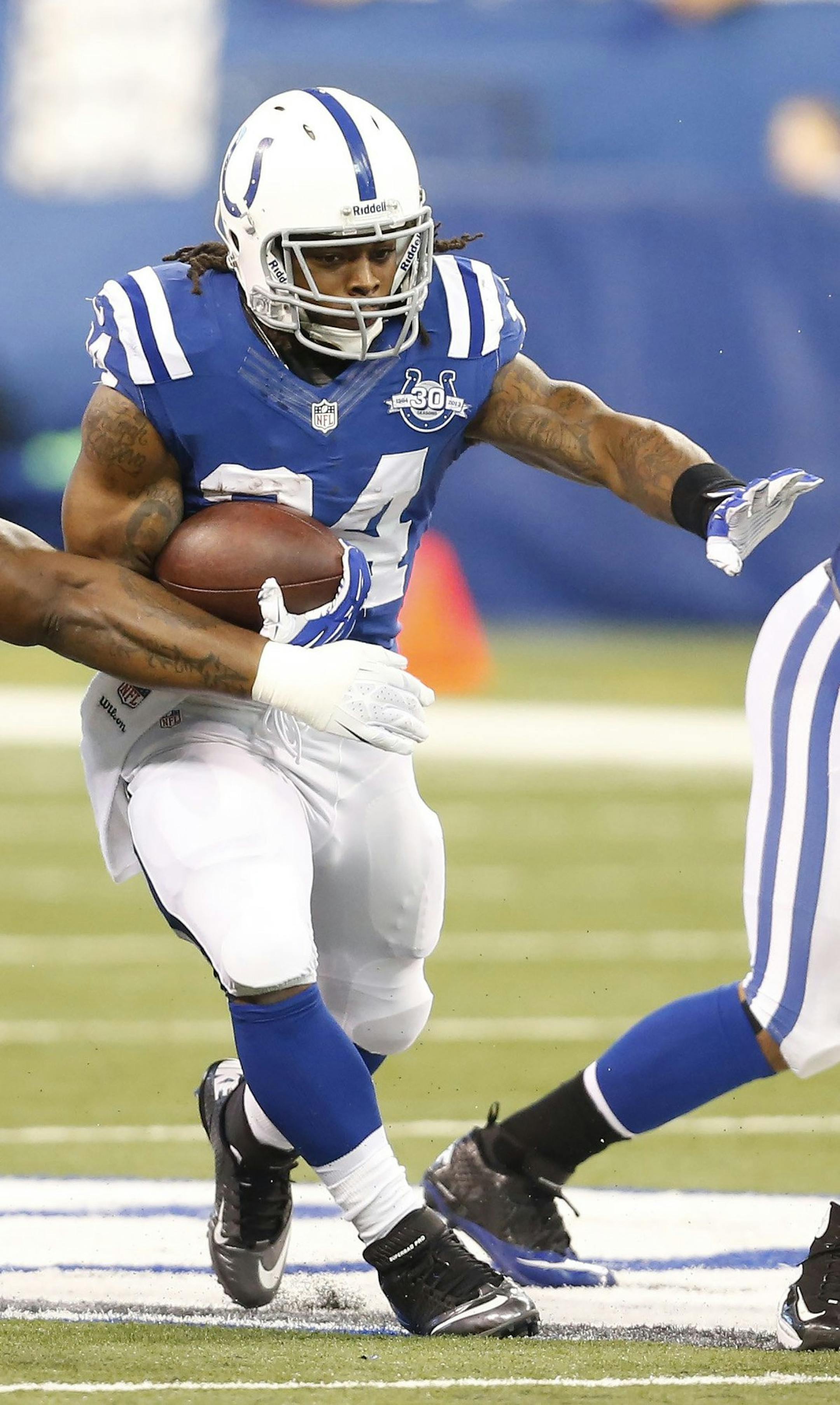 Indianapolis Colts running back Trent Richardson (34) runs through the line in second half action. The Colts host the Tennessee Titans at Lucas Oil Stadium on the on Sunday, Dec. 1, 2013, in Indianapolis. The Colts won the game 22-14. (Sam Riche/MCT) ORG XMIT: 1145428 ORG XMIT: MIN1312011555402381