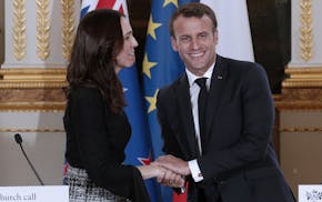 New Zealand Prime Minister Jacinda Ardern, left, and French President Emmanuel Macron, shake hands after a press conference at the Elysee Palace, in P