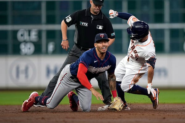Houston’s Jose Altuve tried to stretch a single into a double and was tagged out by Twins shortstop Carlos Correa on Wednesday.