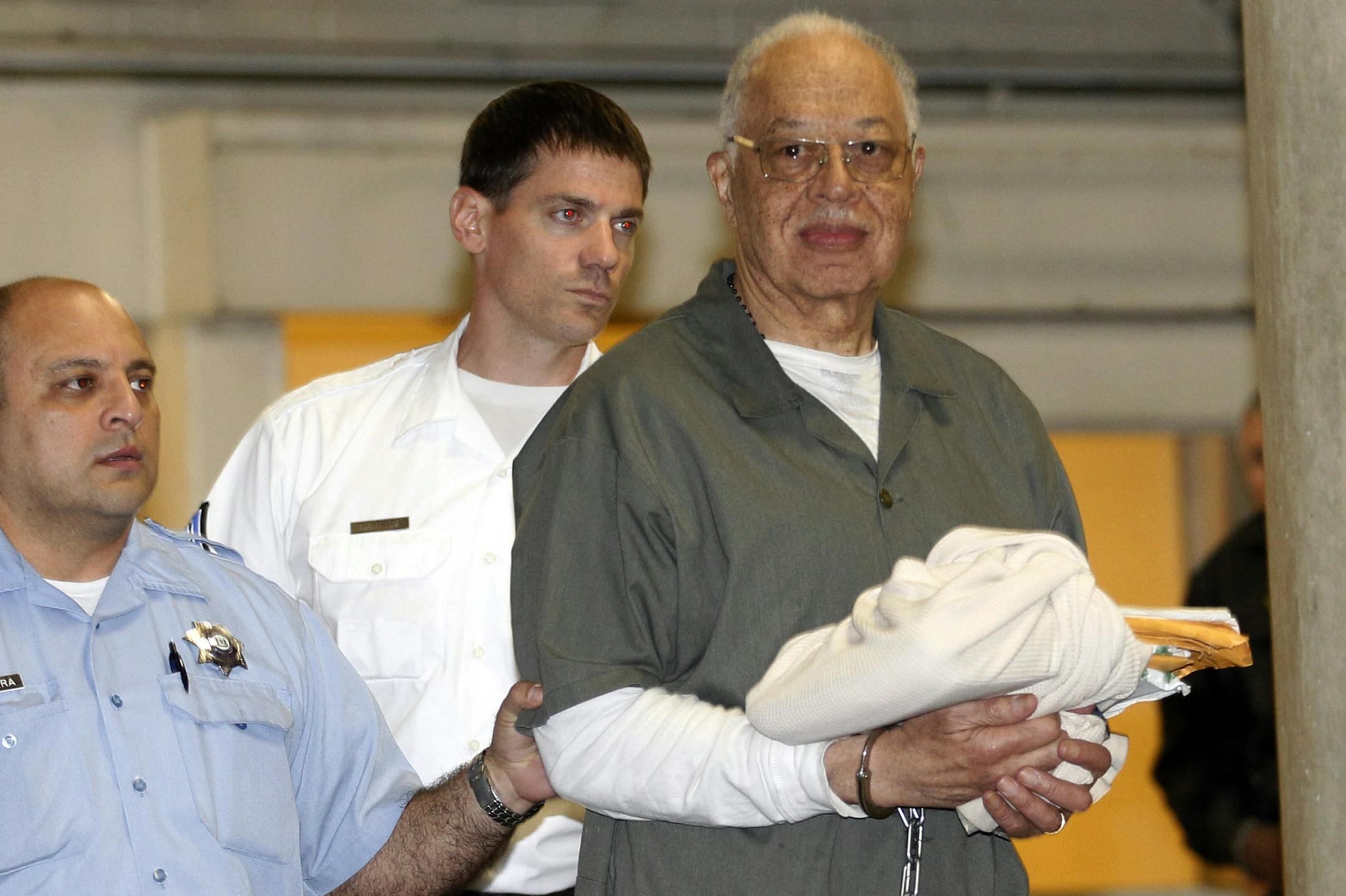 Dr. Kermit Gosnell is escorted to a waiting police van upon leaving the Criminal Justice Center in Philadelphia after being convicted of first-degree murder.