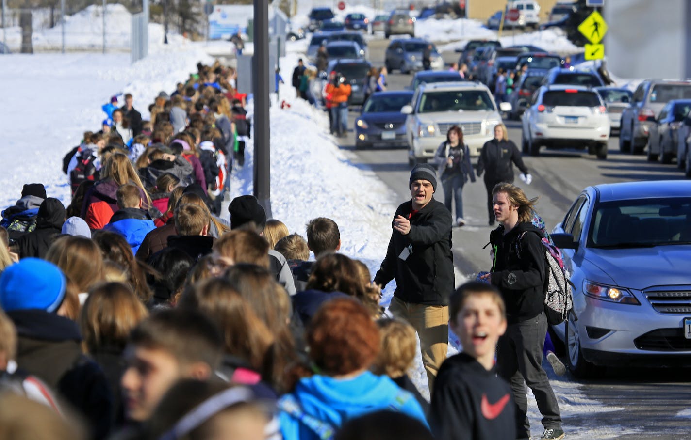 There was a scare in New Prague Wednesday morning when a 911 call about an active shooter proved unfounded. But the School District has notified parents that it calling off classes in all schools for the rest of the day. Here, students are ushered back to The New Prague Middle School after the all clear. ] New Prague, MN - 03/20/2012