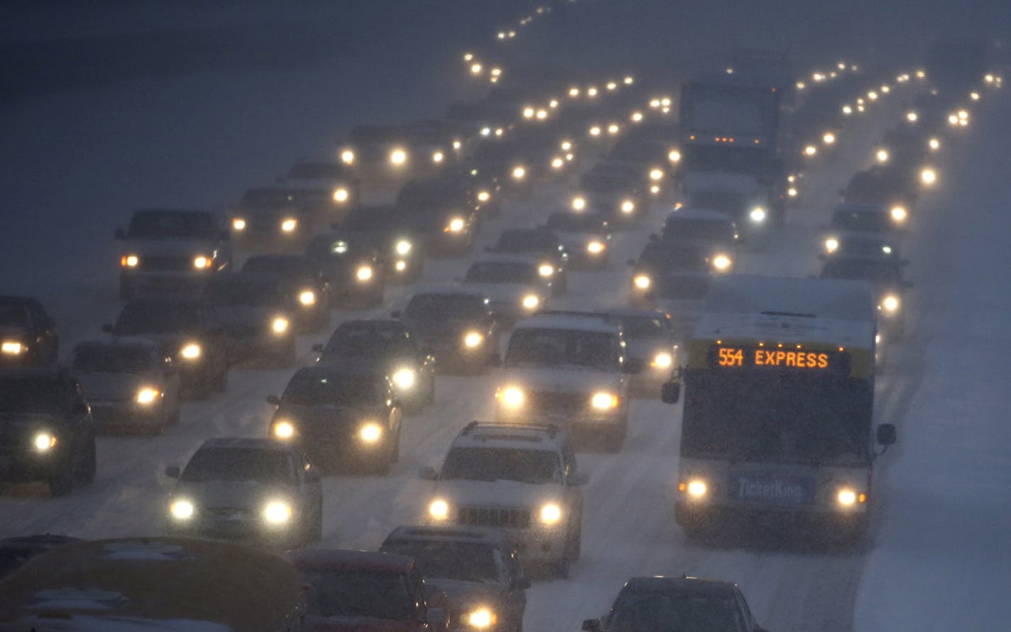 Seen from the 42nt Steet S. Bridge over I-35W bridge, traffic headed north was anything but express as a larger than predicted snowfall greeted commuters Thursday, Jan. 30, 2014, in Minneapolis, MN.](DAVID JOLES/STARTRIBUNE) djoles@startribune.com A larger than expected snowfall snarled traffic throughout the Twin Cities, more than tripling the commute time for many. ORG XMIT: MIN2014013010424508