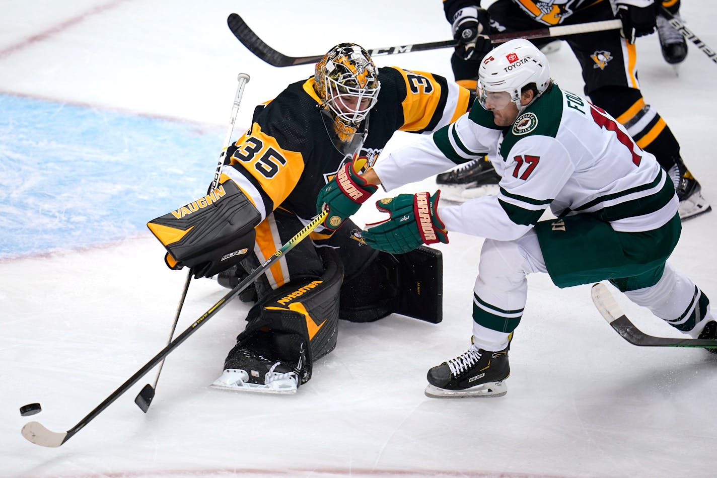 Minnesota Wild's Marcus Foligno (17) can't get a shot off against Pittsburgh Penguins goaltender Tristan Jarry during the first period of an NHL hockey game in Pittsburgh, Saturday, Nov. 6, 2021. (AP Photo/Gene J. Puskar)