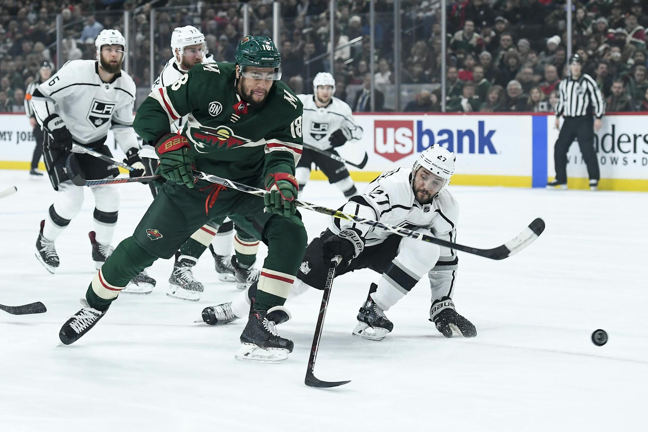 Minnesota Wild left wing Jordan Greenway (18) attempted a shot while being defended by Los Angeles Kings defenseman Alec Martinez (27) in the first period.