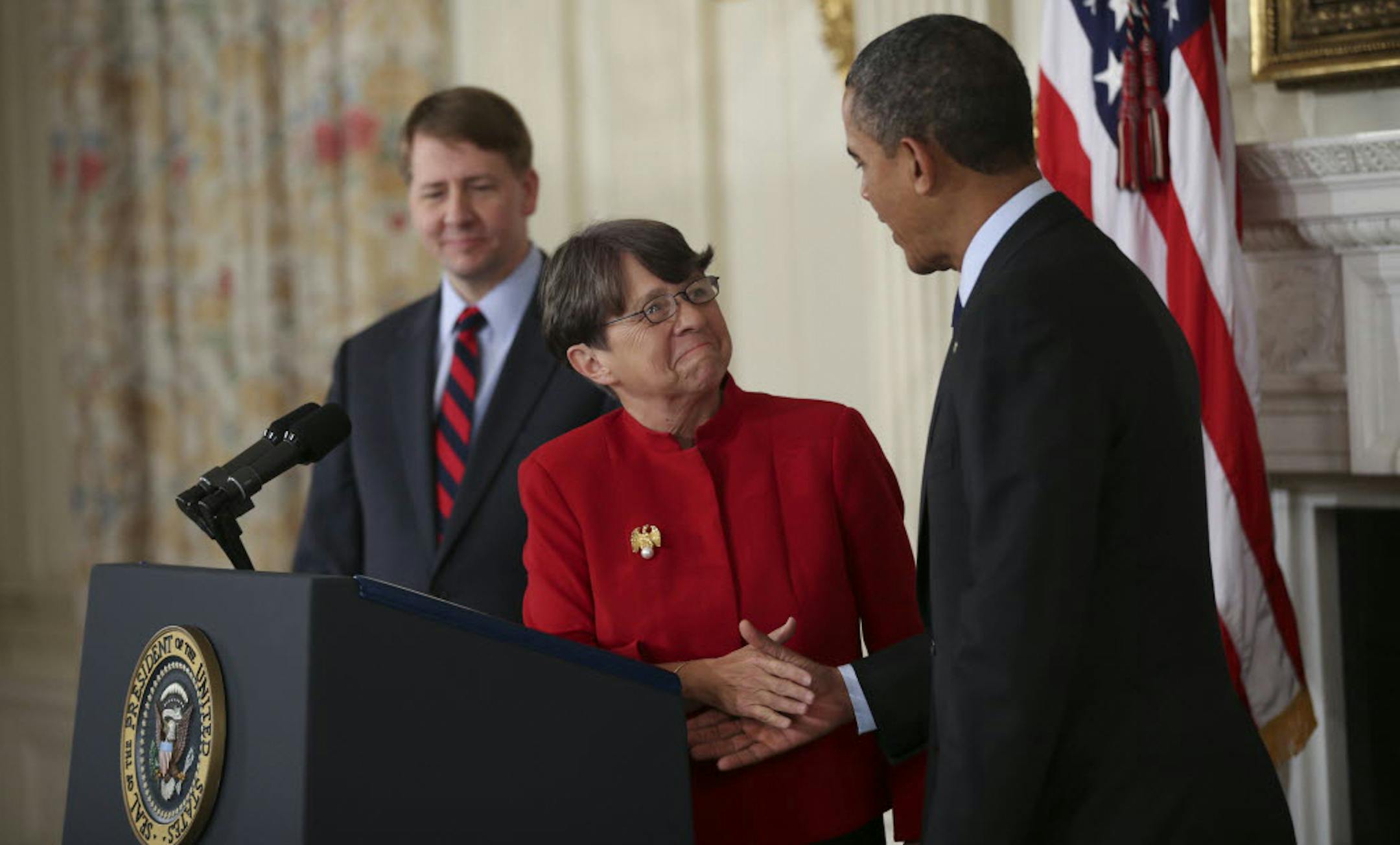 From left: Richard Cordray, Director of the Consumer Financial Protection Bureau, Mary Jo White, a former U.S. attorney turned white collar defense lawyer, and President Barack Obama in the State Dining Room at the White House in Washington.