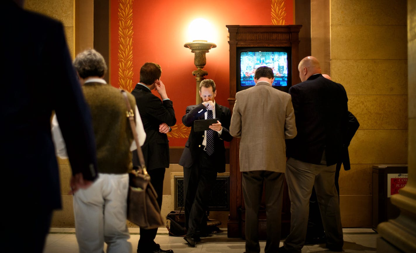 Lobbyists watched debate of the liquor bill, gathering around television monitors outside the Senate Chamber. Bill author Sen Metzen tabled his bill after Sunday growler sales was added back into the bill. ] Tuesday, May 6, 2014 GLEN STUBBE * gstubbe@startribune.com