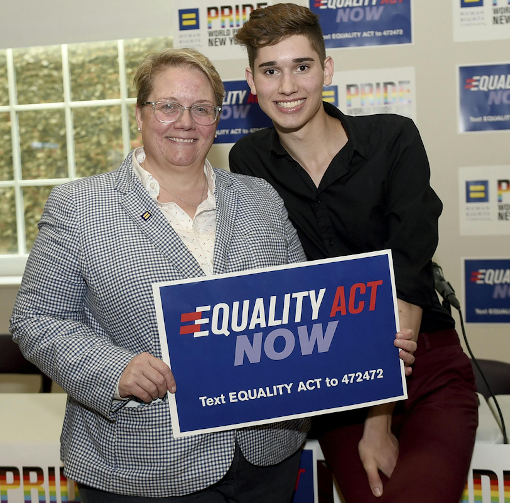 IMAGE DISTRIBUTED FOR HUMAN RIGHTS CAMPAIGN- JoDee Winterhof, left, Human Rights Campaign SVP for Policy and Political Affairs, takes a photo with HRC Youth Ambassador Seth Owen at "Stonewall at 50: The State of LGBTQ Rights," a panel discussion on the battle in Congress to pass the Equality Act and the current landscape of LGBTQ protections in America, Friday, June 28, 2019, in New York at the LGBT Community Center. (Diane Bondareff/AP Images for Human Rights Campaign) ORG XMIT: MER36a03ec1549b