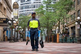 Downtown safety captain Travion Thompson, with the St. Paul Downtown Alliance, patrols on Tuesday.