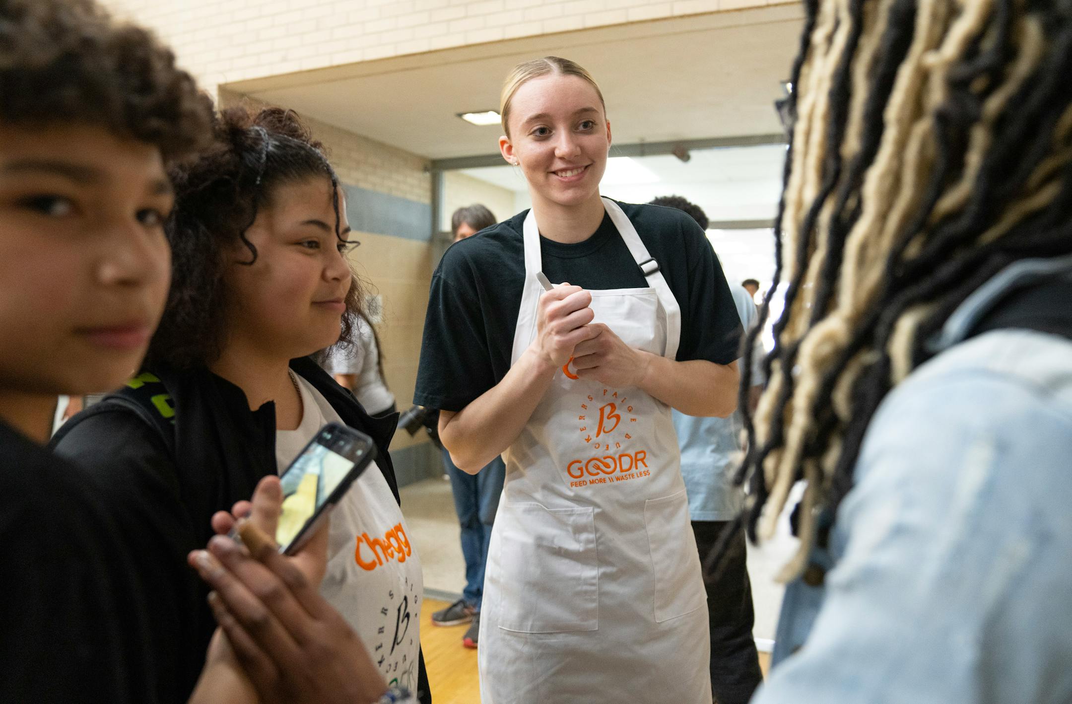 Paige Bueckers speaks with students before a grand opening ceremony for a new free grocery store on Thursday, April 13, 2023 at Hopkins West Junior High School in Minnetonka.