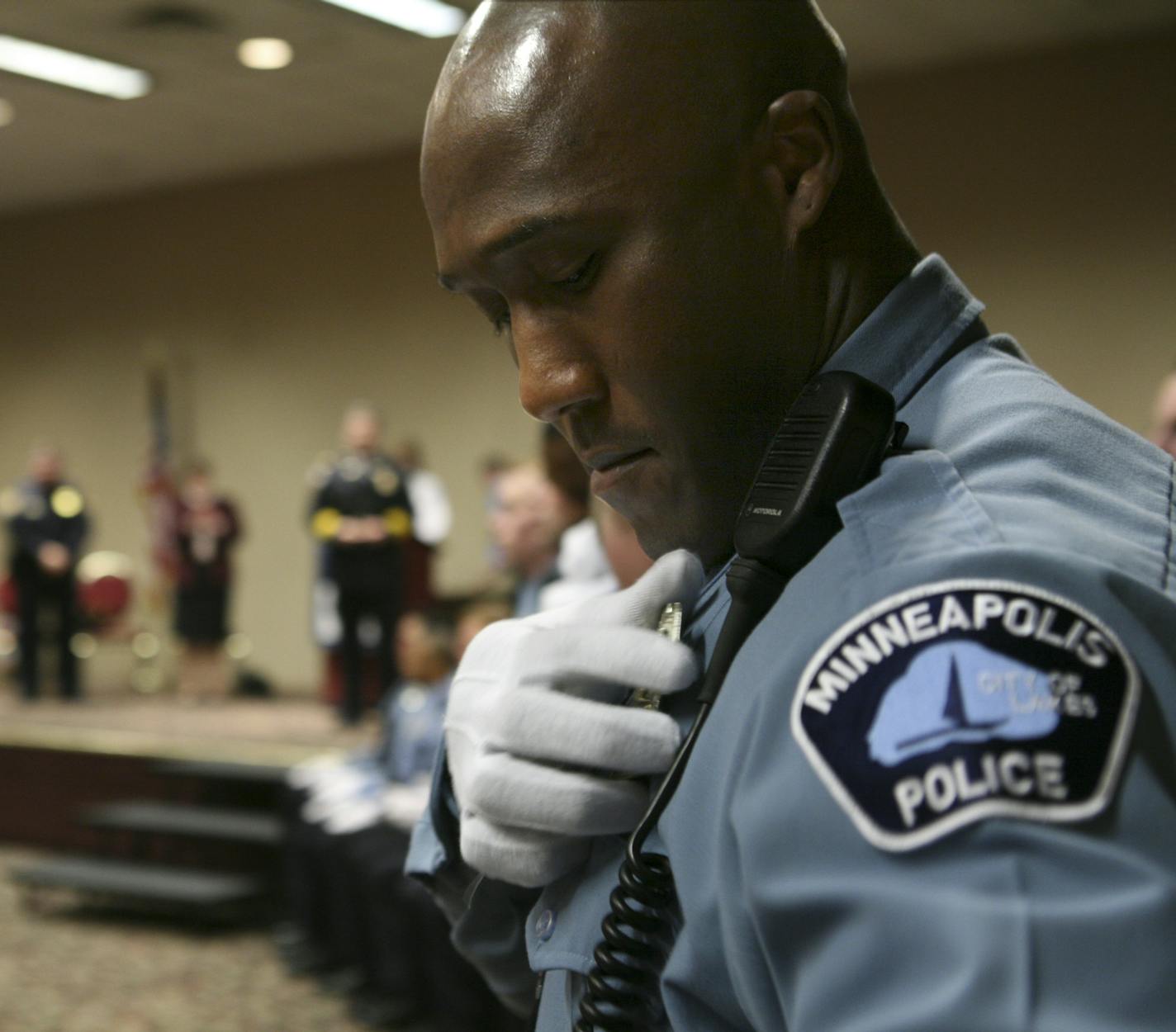 New Minneapolis Police Department Academy graduate Michael Griffin pins his badge onto his uniform moments after receiving it from Police Chief Tim Dolan at the graduation ceremony Thursday evening. GENERAL INFORMATION: JEFF WHEELER &#x2022; jwheeler@startribune.com MINNEAPOLIS - Minneapolis Mayor R.T. Rybak attended the graduation ceremony for two classes of Minneapolis Police Department recruits Thursday evening at the Zuhrah Shrine Center in Minneapolis. The police department gained 31 new of