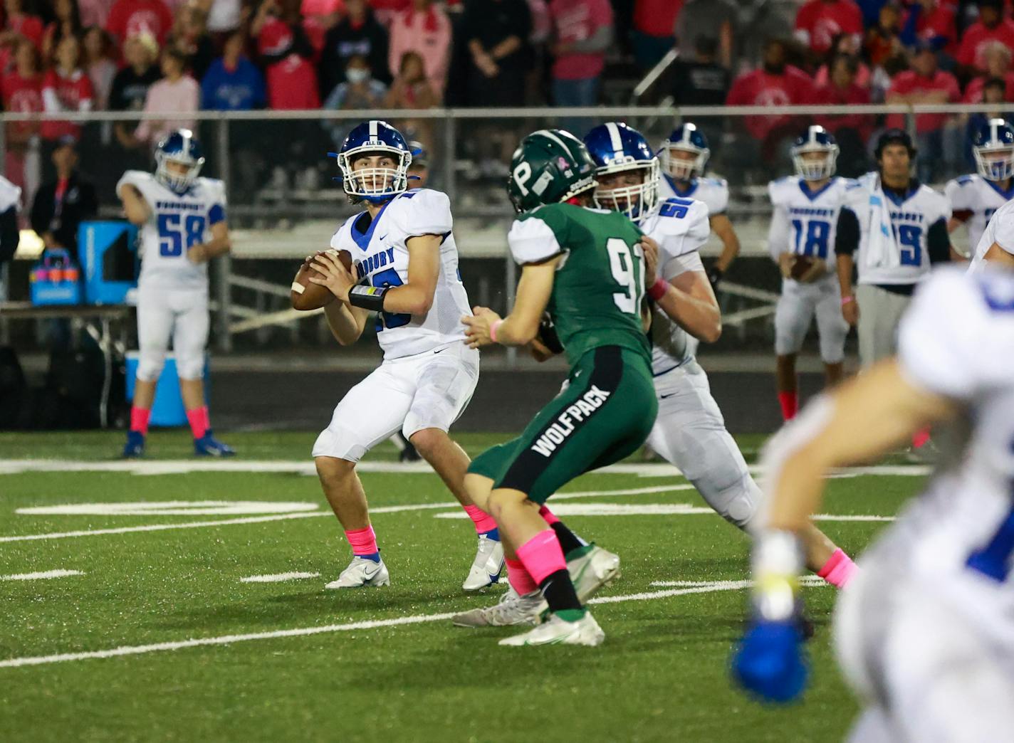 Sophomore quarterback George Bjellos (16) threw four passing touchdowns and added a fifth rushing touchdown leading Woodbury to a 55-21 win over Park High School. Photo by Cheryl A. Myers, SportsEngine