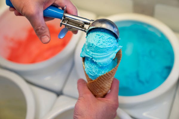 “It’s definitely one of our top selling flavors,” said Darrell Hauge, owner of Flamingos Ice Cream & Treats, photographed scooping Blue Moon ice