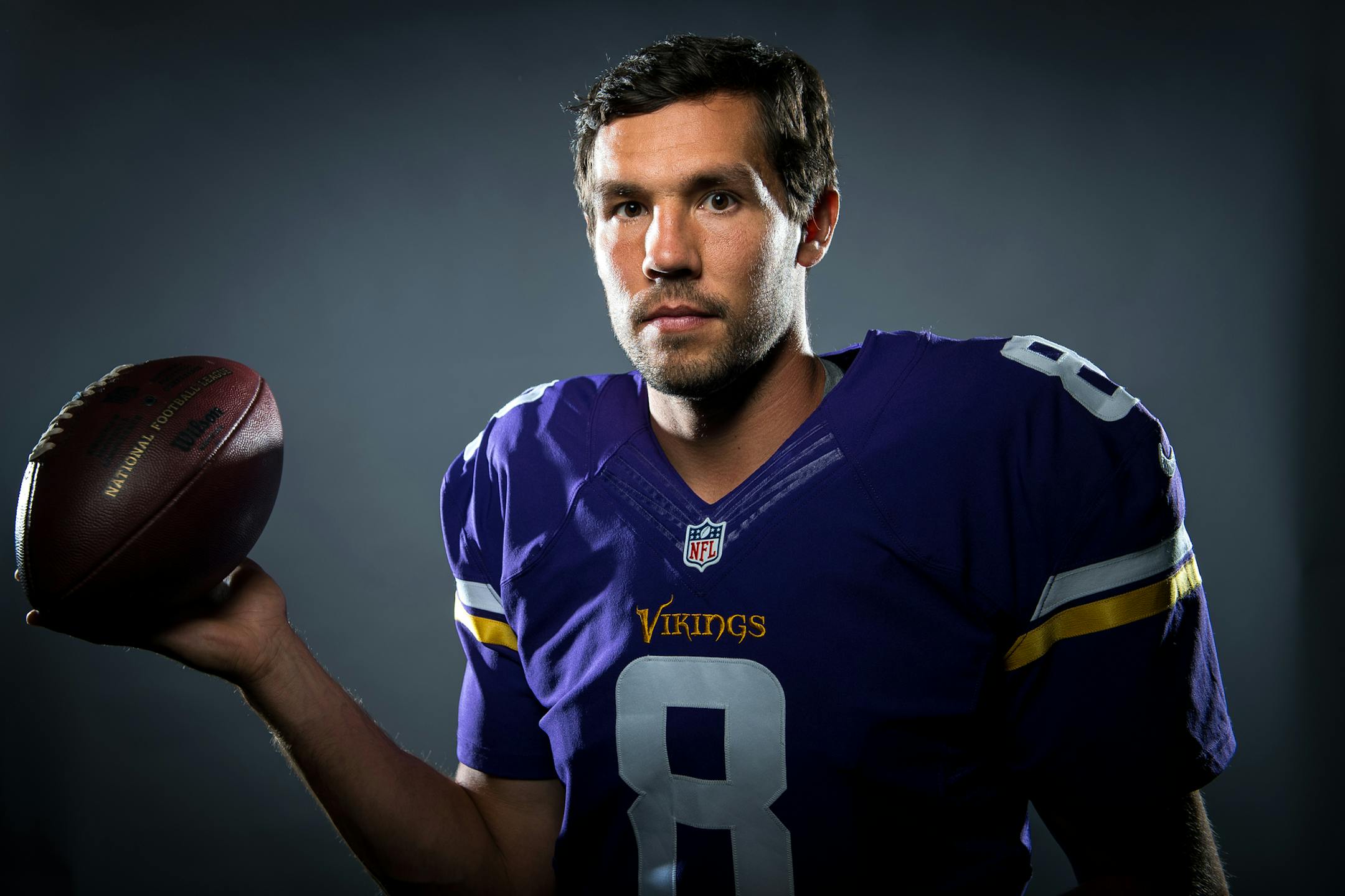 Sam Bradford, playing for his third team in his seventh NFL season, posed in his Vikings uniform on Friday. The Vikings open their 56th season on Sunday.