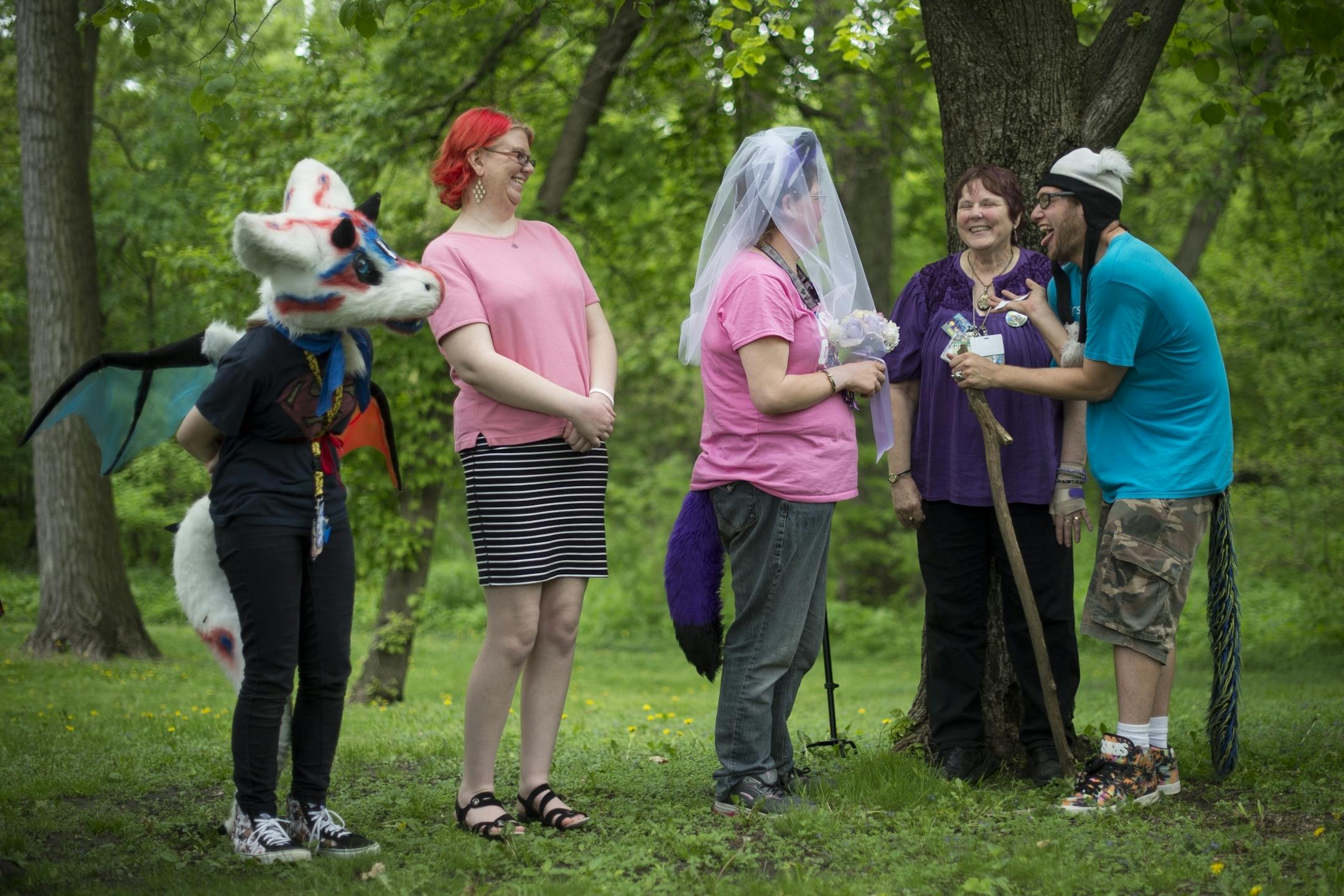 Joey Mullen, right, stuck out his tongue in joy before kissing Kelly McLaughlin at their wedding during the MN Furs spring picnic in mid-May.