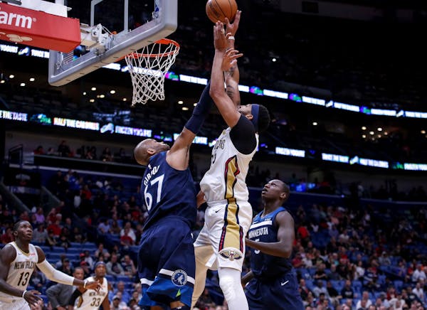 New Orleans Pelicans forward Anthony Davis (23) shoots over Minnesota Timberwolves forward Taj Gibson (67) in the second half of an NBA basketball gam