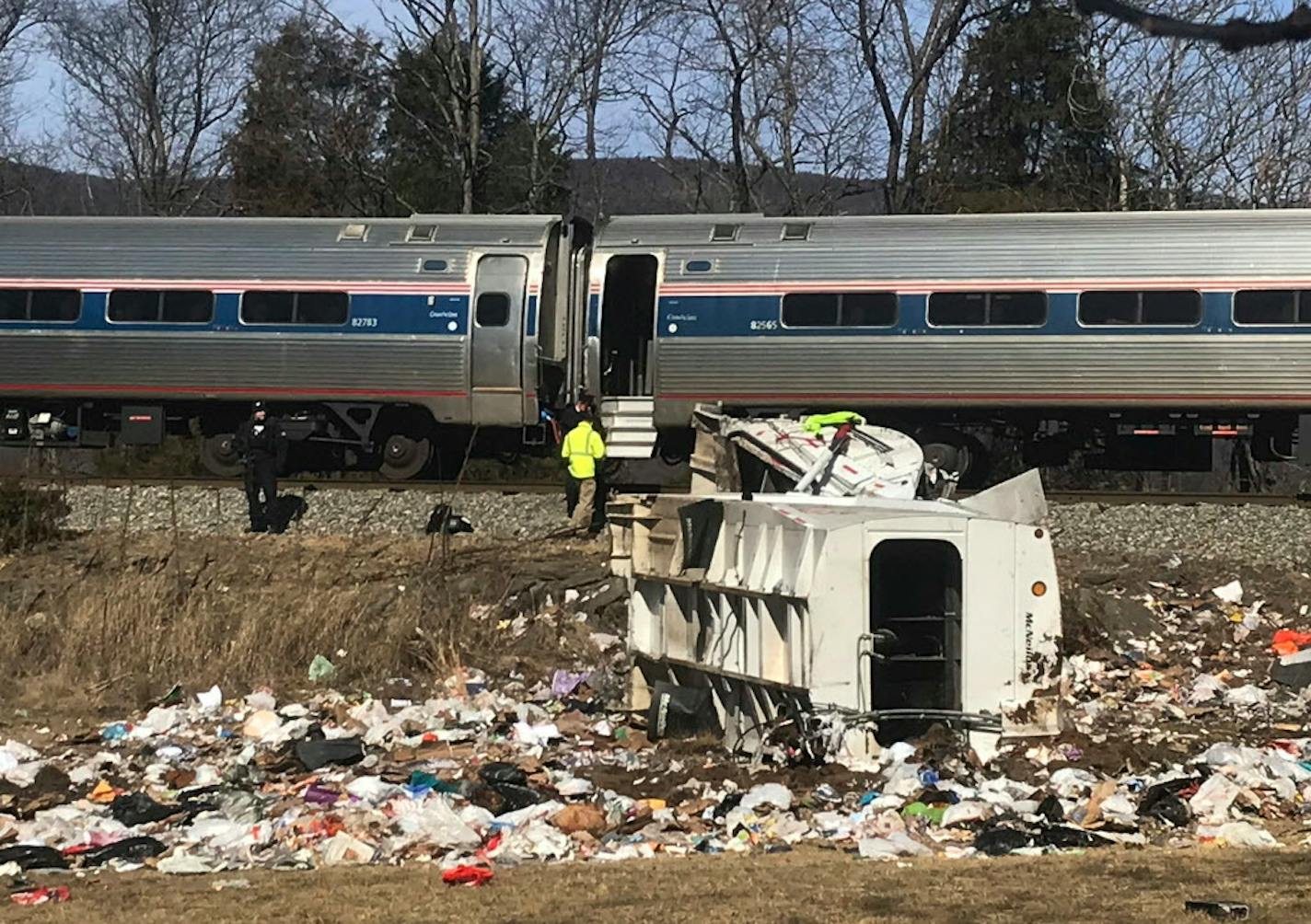 Emergency personnel work at the scene of a train crash involving a garbage truck in Crozet, Va., on Wednesday, Jan. 31, 2018. An Amtrak passenger train carrying dozens of GOP lawmakers to a Republican retreat in West Virginia struck a garbage truck south of Charlottesville, Va. No lawmakers were believed injured. (Zack Wajsgrasu/The Daily Progress via AP)