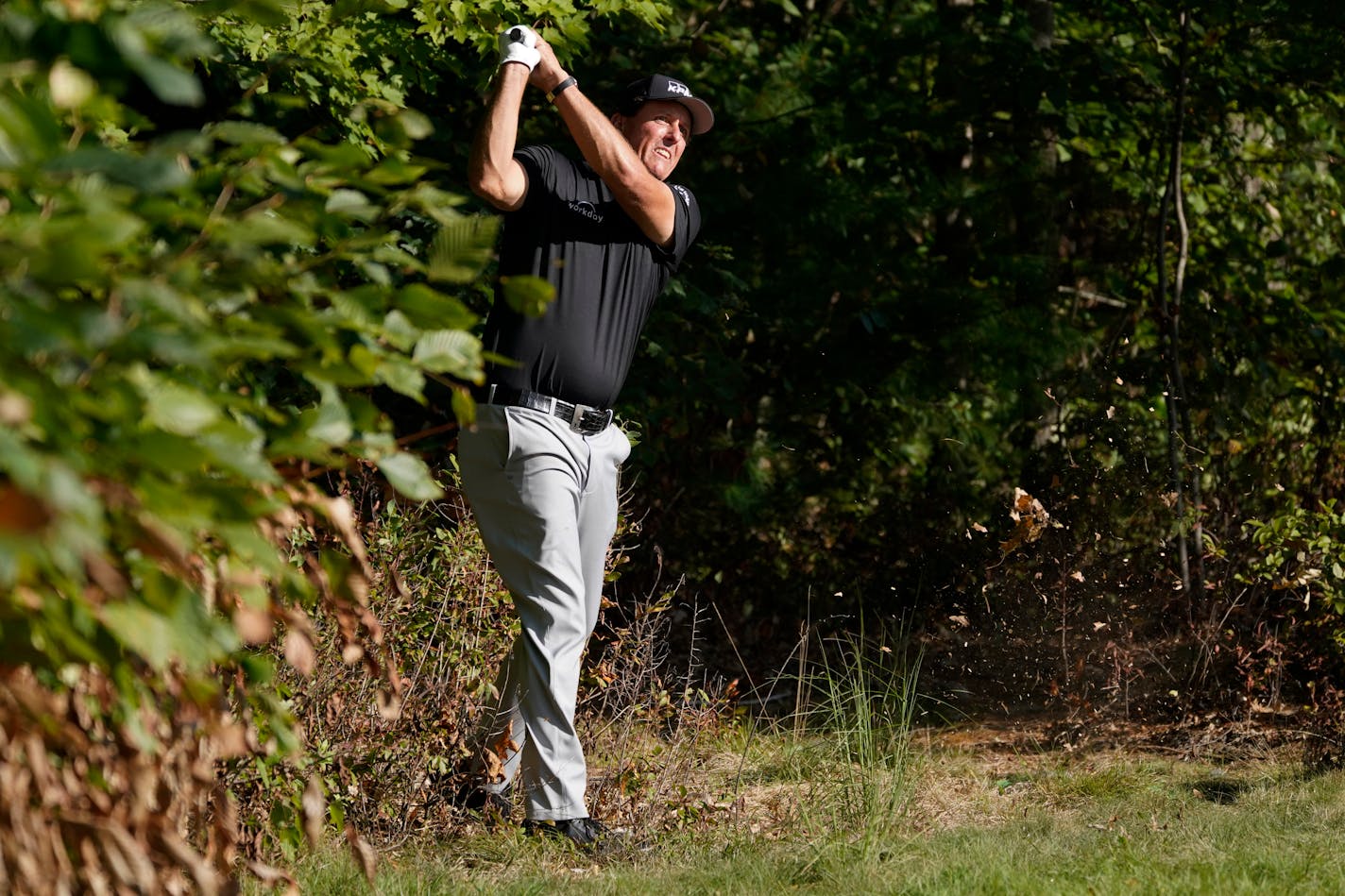 Phil Mickelson (shown playing in last week's Northern Trust golf tournament) made five straight birdies on the back nine to shoot a 10-under 61 on Monday and take a one-shot lead in his debut on the PGA Tour Champions.