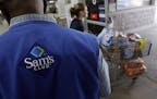 A store associate watches as a customer leaves with her purchases at Sam's Club in Jackson, Miss., Thursday, Sept. 9, 2010. Inventories held by wholes