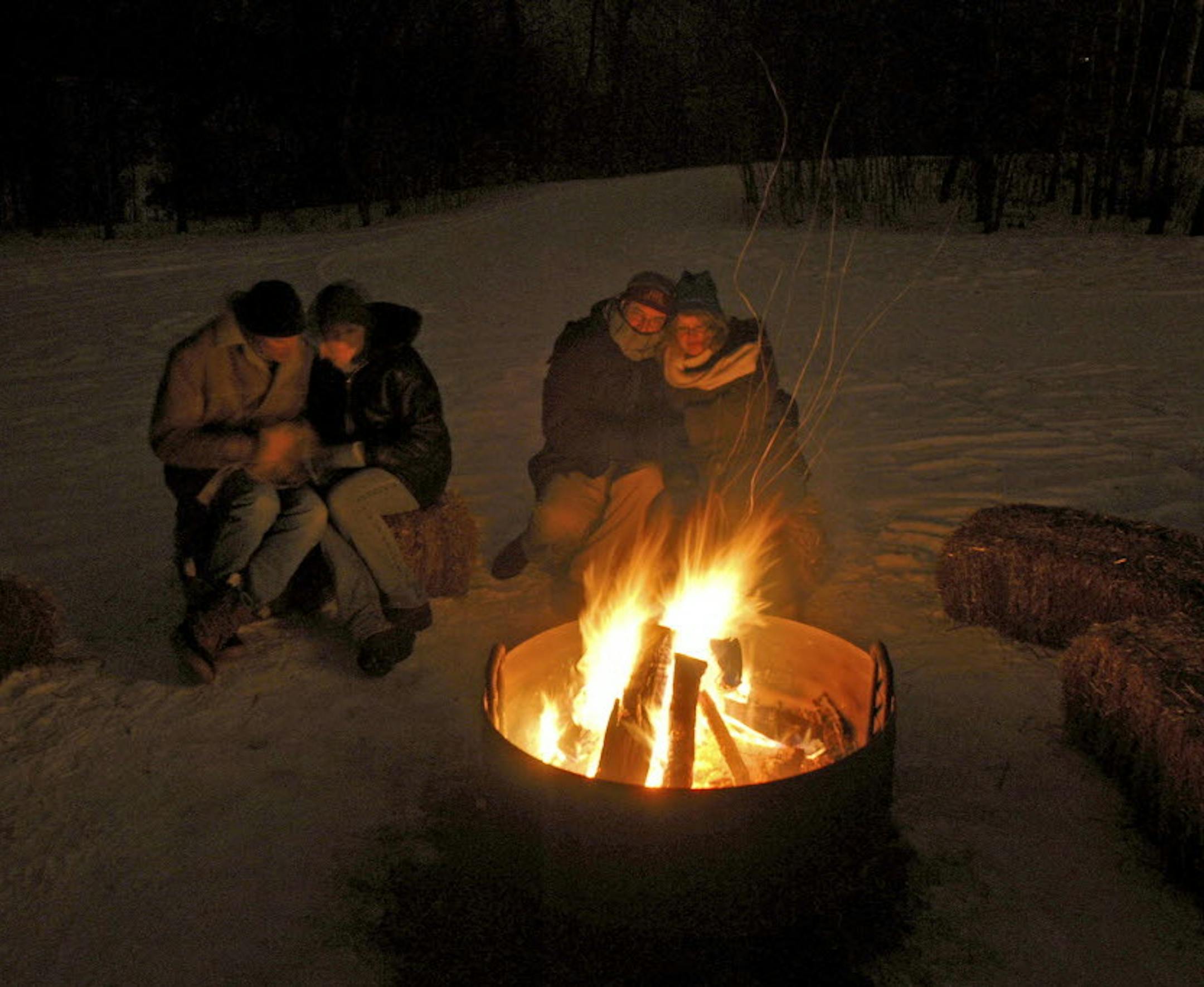 Please Credit Three Rivers Park District. (2/2009) Caption: "Couples enjoy the romance of a bonfire at Richardson Nature Center's candlelight and chocolate Valentine's Day program in 2007. Derek J. Dickinson
