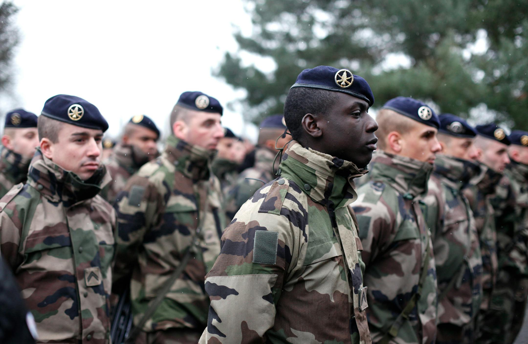 French soldiers line up to listen to a speech by the French Defense Minister Jean Yves Le Drian, at the Satory military camp in Versailles, west of Paris, Thursday, Jan. 15, 2015. France ordered 10,000 troops into the streets Monday to protect sensitive sites — nearly half of them to guard Jewish schools — as it hunted for accomplices to the Islamic militants who left 17 people dead as they terrorized the nation. (AP Photo/Thibault Camus)