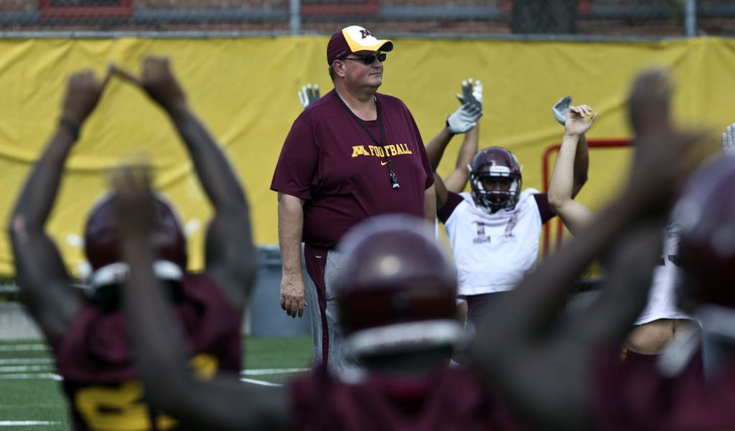 Tracy Claeys watched players go through warm-ups in August 2011.