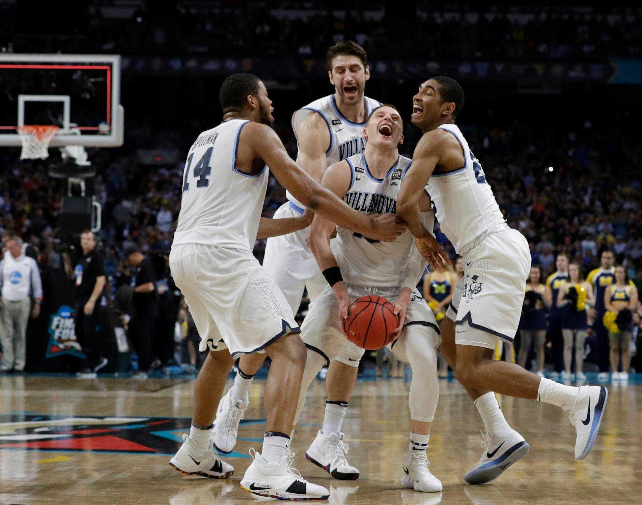 Villanova guard Donte DiVincenzo, center, celebrates with teammates at the end of the championship game against Michigan in the Final Four NCAA college basketball tournament, Monday, April 2, 2018, in San Antonio. Villanova won 79-62. (AP Photo/David J. Phillip)