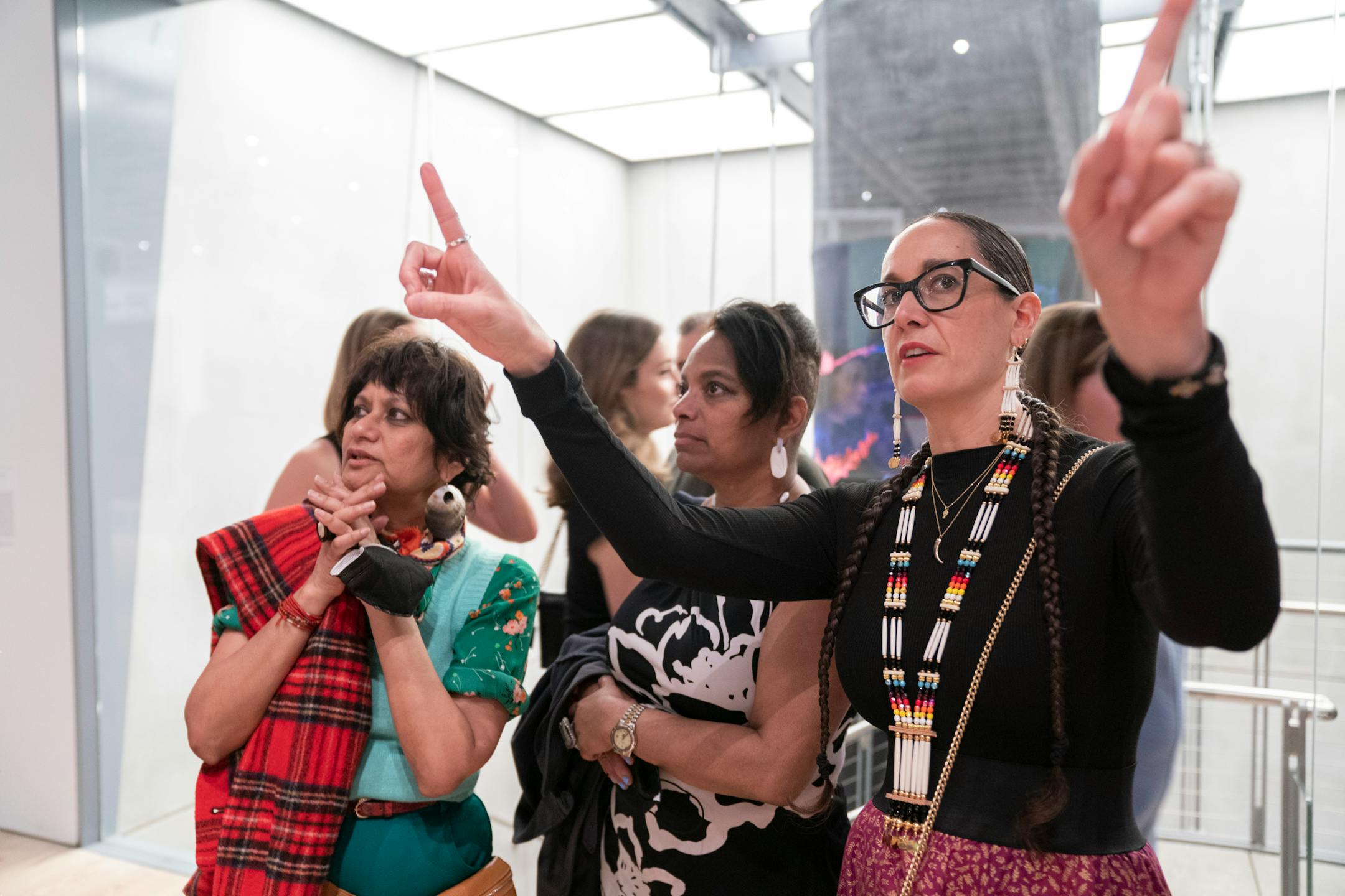 Dyani Whitehawk, right, talks with Kymberly Pinder, Dean,Yale School of Art, middle, and Rina Banerjee, a NYC Artist at the Whitney Museum of Art during its Biennial in New York , NY., on Wednesday, March 30, 2022. Barry Williams