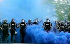 Minnesota State Police officers approach a crowd of protesters in Minneapolis on May 30, 2020. The Minnesota State Patrol purged e-mails and texts mes