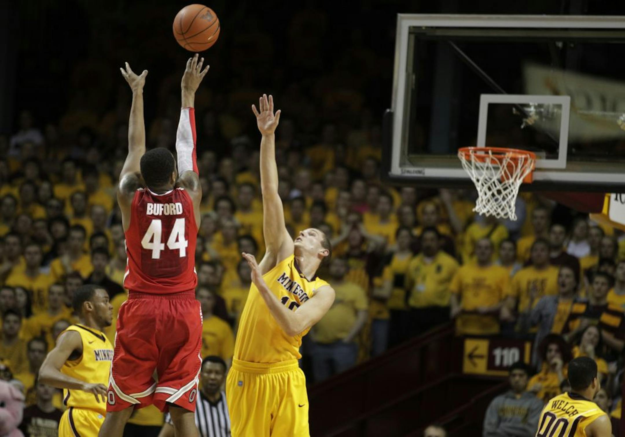 Ohio State's William Buford hit a 3-point shot over Minnesota's Oto Osenieks during Tuesday night's matchup between Ohio State and the University of Minnesota February 14, 2012 in Minneapolis, Minnesota. Ohio State beat Minnesota 78-68.