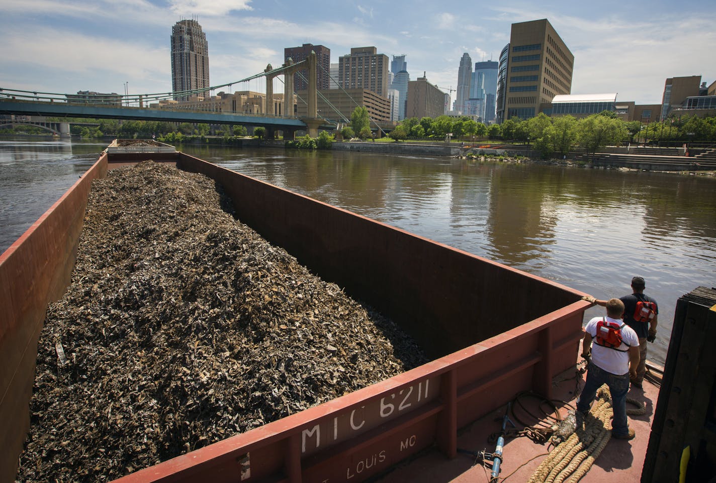 Zac Burns and Charles Kroska worked the last tow of scrap metal down the river from Northern Metal Recycling in Minneapolis.