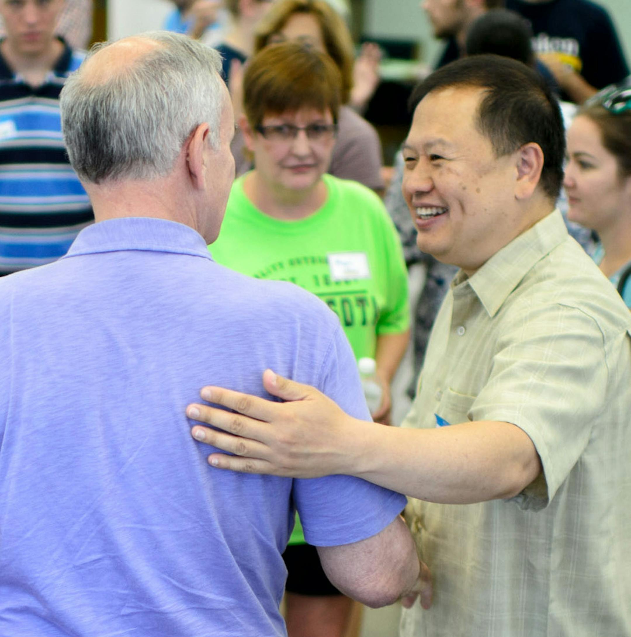 Governor Mark Dayton talked with State Sen. Foung Hawj while visiting supporters at the St. Paul DFL field office as part of the 20-location kickoff to mark 100 days until the November election. Sunday, July 25, 2014. ] GLEN STUBBE * gstubbe@startribune.com ORG XMIT: MIN1407271913450311
