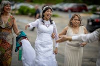 Friends help Maria Carmen Morra, center, on her wedding day. A community made sure the stage 4 breast cancer survivor could fulfill her dreams of marr