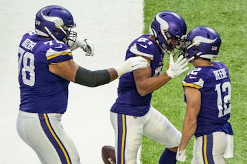 Vikings offensive guard Dakota Dozier (78) and wide receiver Bisi Johnson (81) swarm wide receiver Chad Beebe (12) after he scored the game winning to