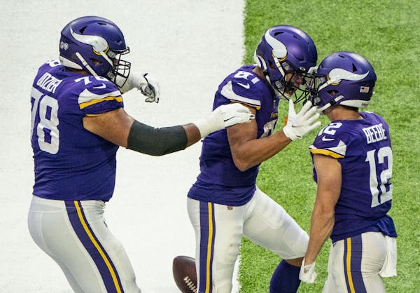 Vikings offensive guard Dakota Dozier (78) and wide receiver Bisi Johnson (81) swarm wide receiver Chad Beebe (12) after he scored the game winning to