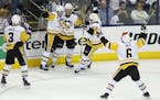 Pittsburgh Penguins' Jake Guentzel, center, celebrates his game-winning goal with teammates Olli Maatta, left to right, of Finland, Sidney Crosby, Con