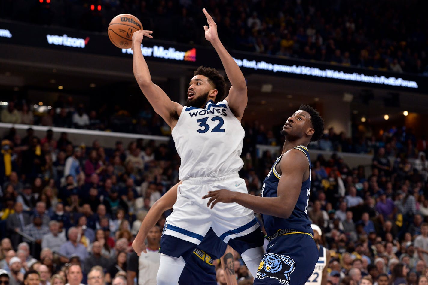 Timberwolves center Karl-Anthony Towns passes the ball away from Memphis forward Jaren Jackson Jr. during the second half of Game 2