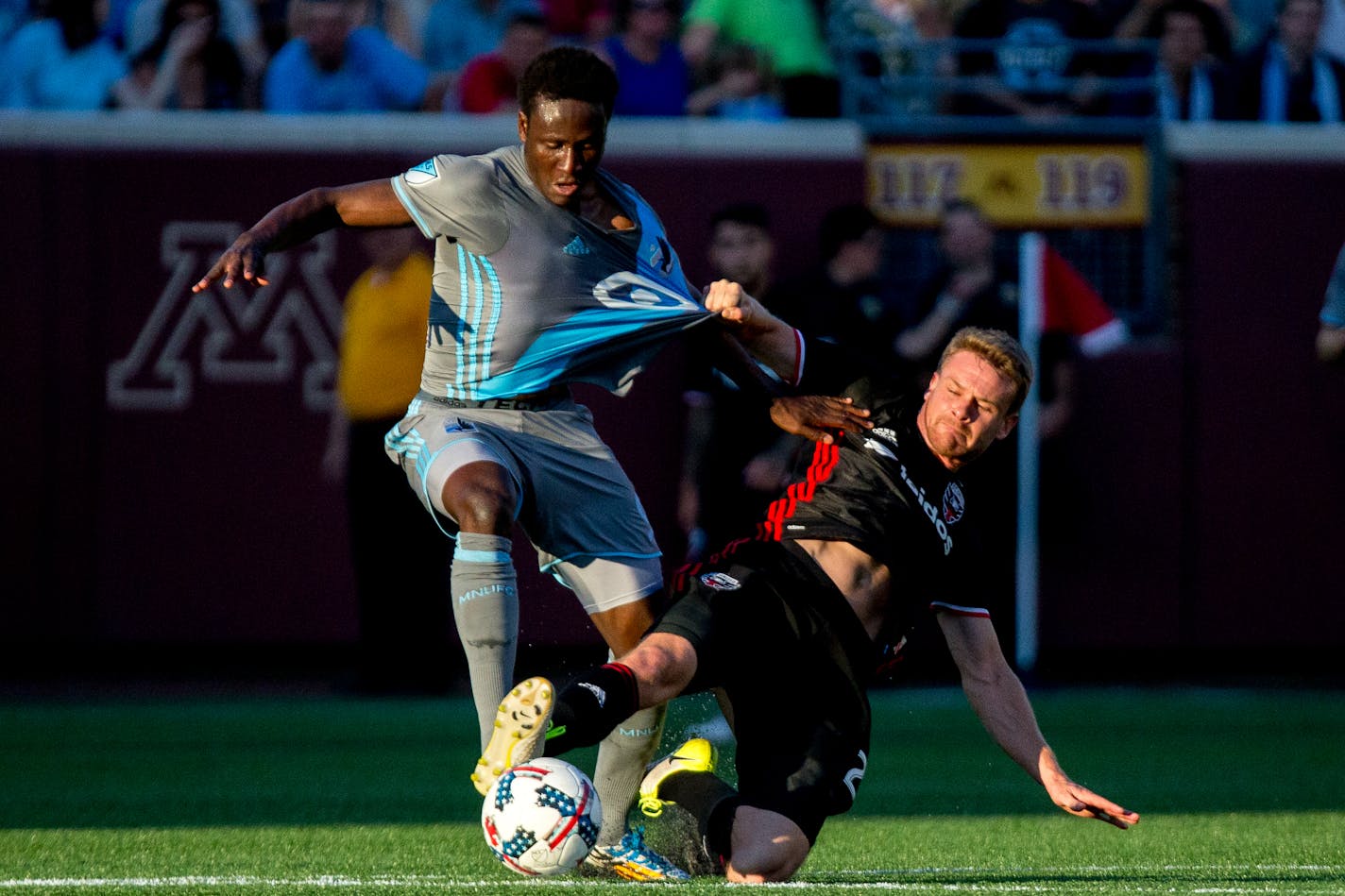 D.C. United's Taylor Kemp, right, grabs Minnesota United forward Abu Danladi's jersey during the first half on Saturday, July 29, 2017, at TCF Bank Stadium in Minneapolis. (Courtney Pedroza/Minneapolis Star Tribune/TNS)