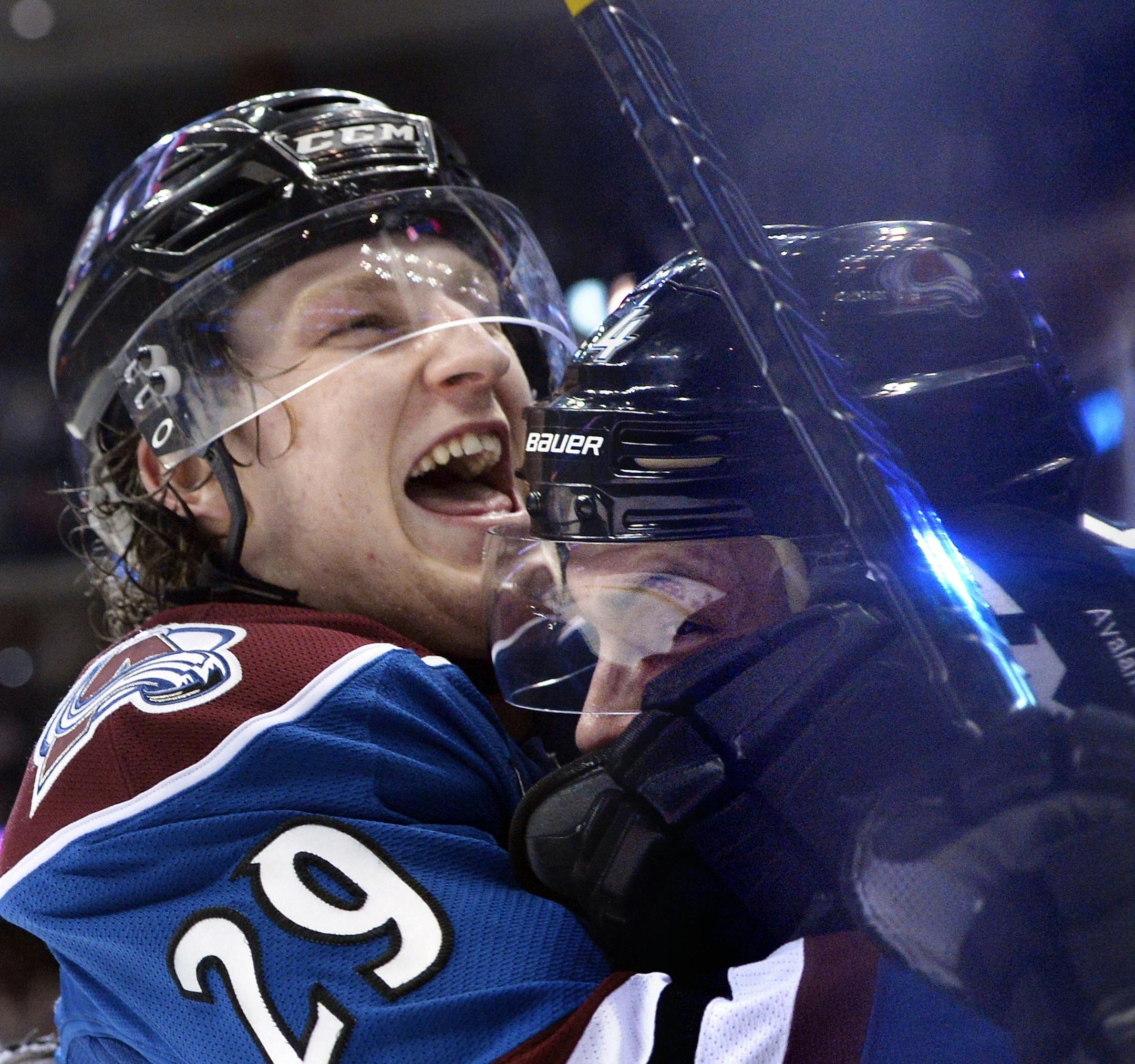 Colorado Avalanche defenseman Tyson Barrie embraces Nathan MacKinnon (29) after scoring a goal to tie the game against the New York Rangers during the third period of an NHL hockey game on Thursday, April 3, 2014, in Denver. Colorado won 3-2 in an overtime shootout. (AP Photo/Jack Dempsey)