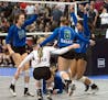 Eagan rushes the court after winning an intense 5 set match against Prior Lake during the Girls 3A State Volleyball Championship Saturday at the Xcel 