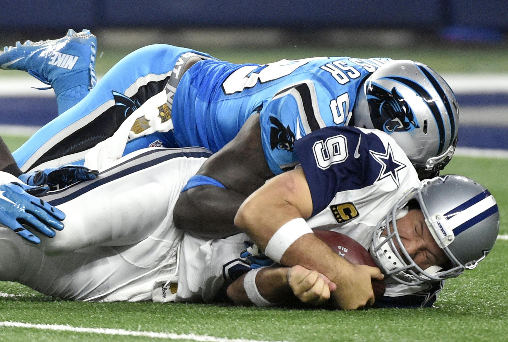 Dallas Cowboys quarterback Tony Romo (9) is sacked by Carolina Panthers outside linebacker Thomas Davis (58) in the second half of an NFL football game, Thursday, Nov. 26, 2015, in Arlington, Texas. Romo was injured on the play and left the game. (AP Photo/Michael Ainsworth)
