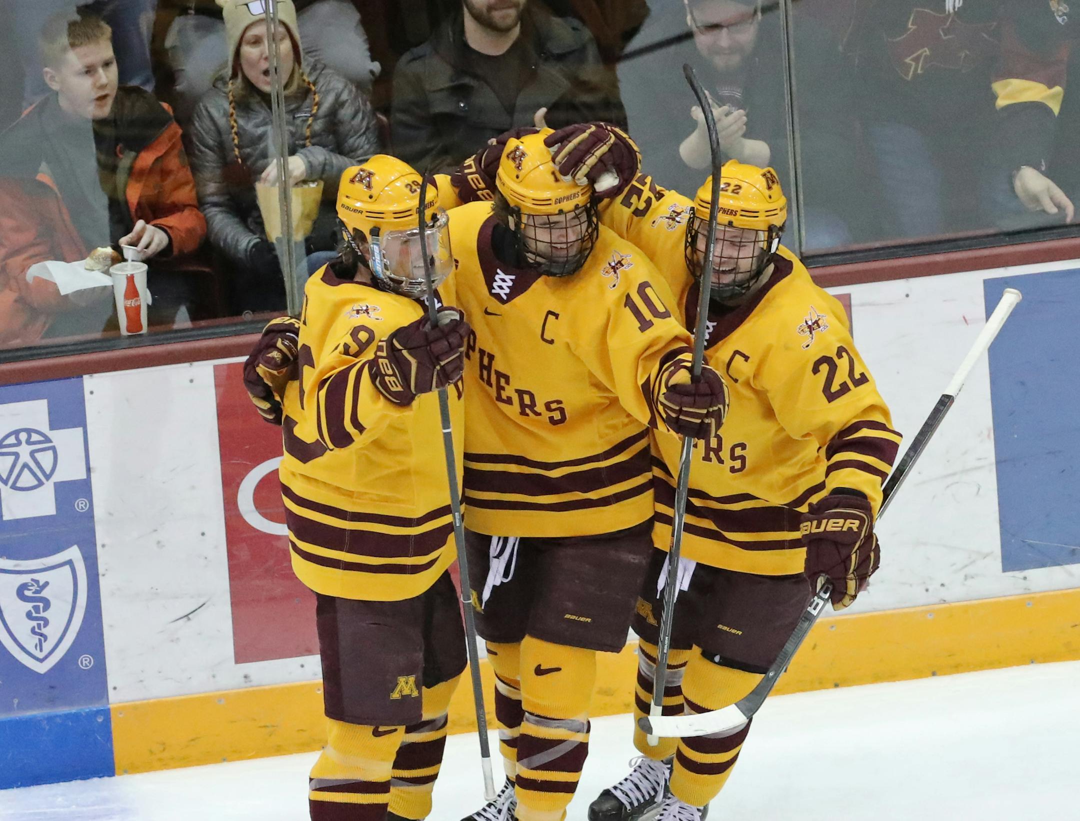 Gophers left wing Brent Gates Jr. (10) celebrated with teammates Tyler Nanne (29) and Tyler Sheehy (22) after scoring a goal in the second period.