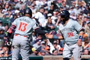The Twins' Carlos Santana is greeted by Manuel Margot after crossing home plate in the 11th inning during the first game of a doubleheader Saturday in