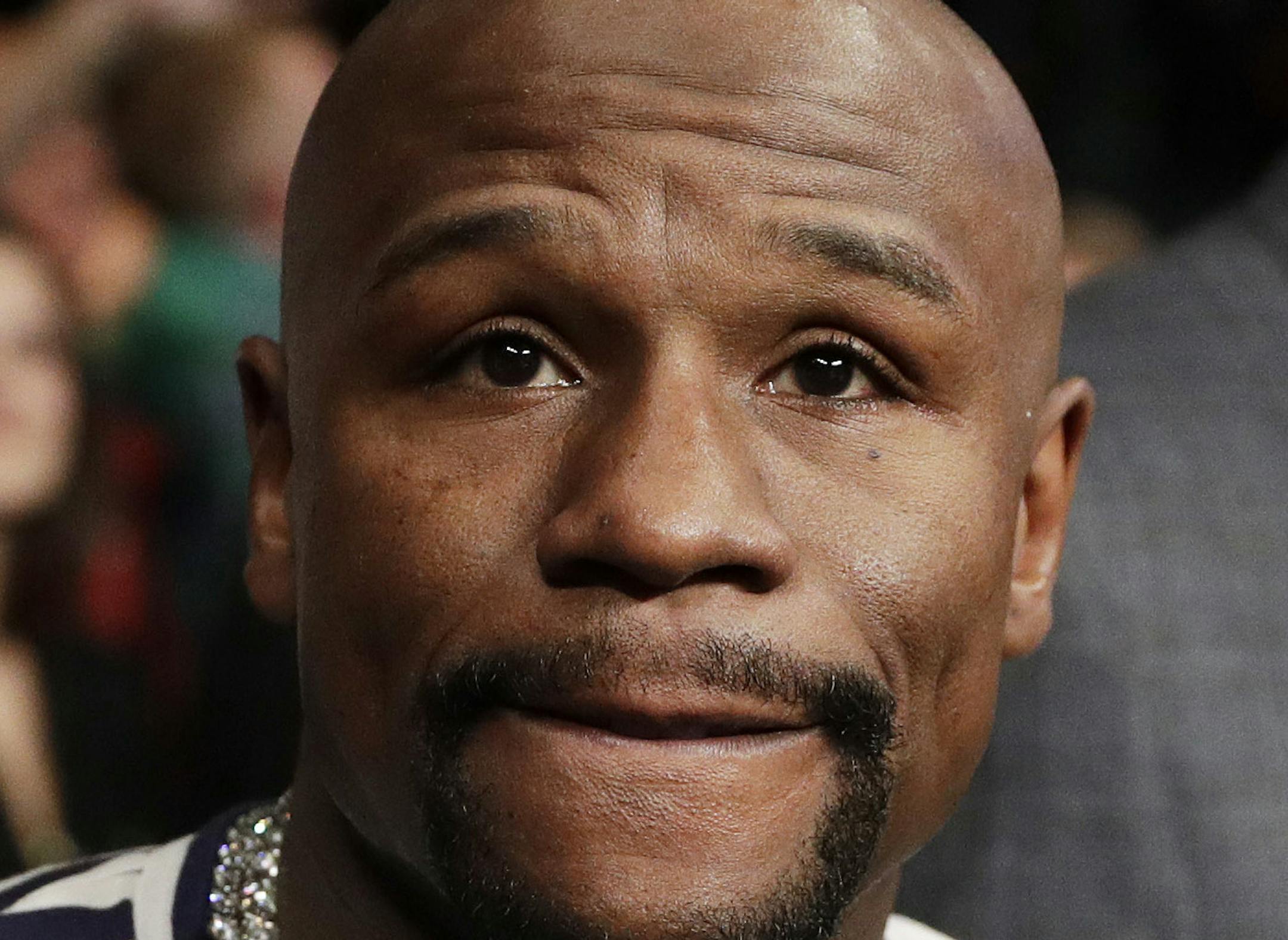 Retired boxer and boxing promoter Floyd Mayweather Jr. attends a fight between Carl Frampton, of Northern Ireland, and Leo Santa Cruz, Saturday, Jan. 28, 2017, in Las Vegas. Mayweather. says facing UFC star Conor McGregor in a boxing ring "can happen" and is something that would "give the fans what they want to see." In a question-and-answer session Saturday in England, McGregor said he plans to put his UFC career on hold to pursue boxing and a bout with Mayweather, who hasn't fought since 2015.