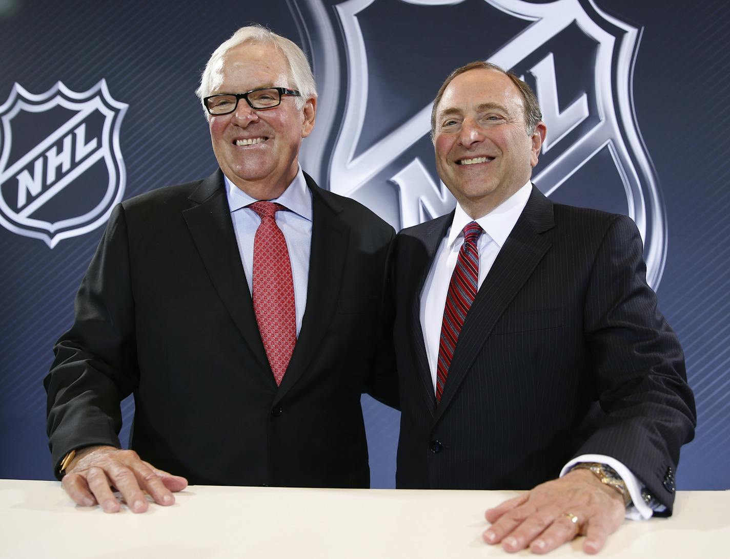 NHL Commissioner Gary Bettman, right, and Bill Foley pose for photographers during a news conference Wednesday, June 22, 2016, in Las Vegas. Bettman announced an expansion franchise to Las Vegas after the league's board of governors met in Las Vegas. Foley is the majority owner of the team. (AP Photo/John Locher)