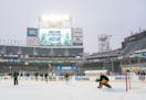 Minnesota Wild right wing Brandon Duhaime (21) takes a shot on goalkeeper Cam Talbot (33) during outdoors practice as a light snow falls at Target Fie