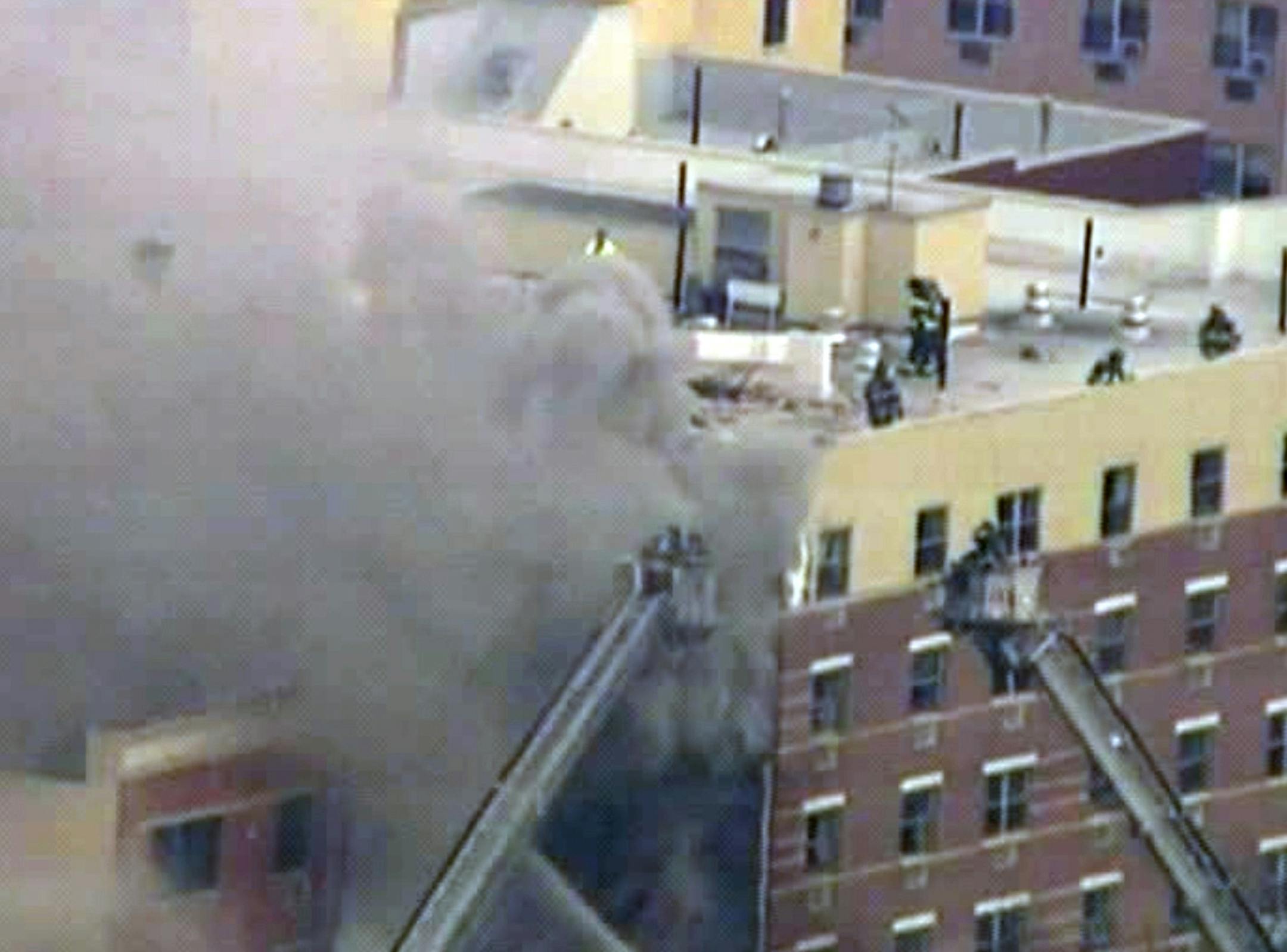 In this image taken from video from WABC, firefighters battle a blaze at the site of a possible explosion and building collapse in the East Harlem neighborhood of New York, Wednesday, March 12, 2014.