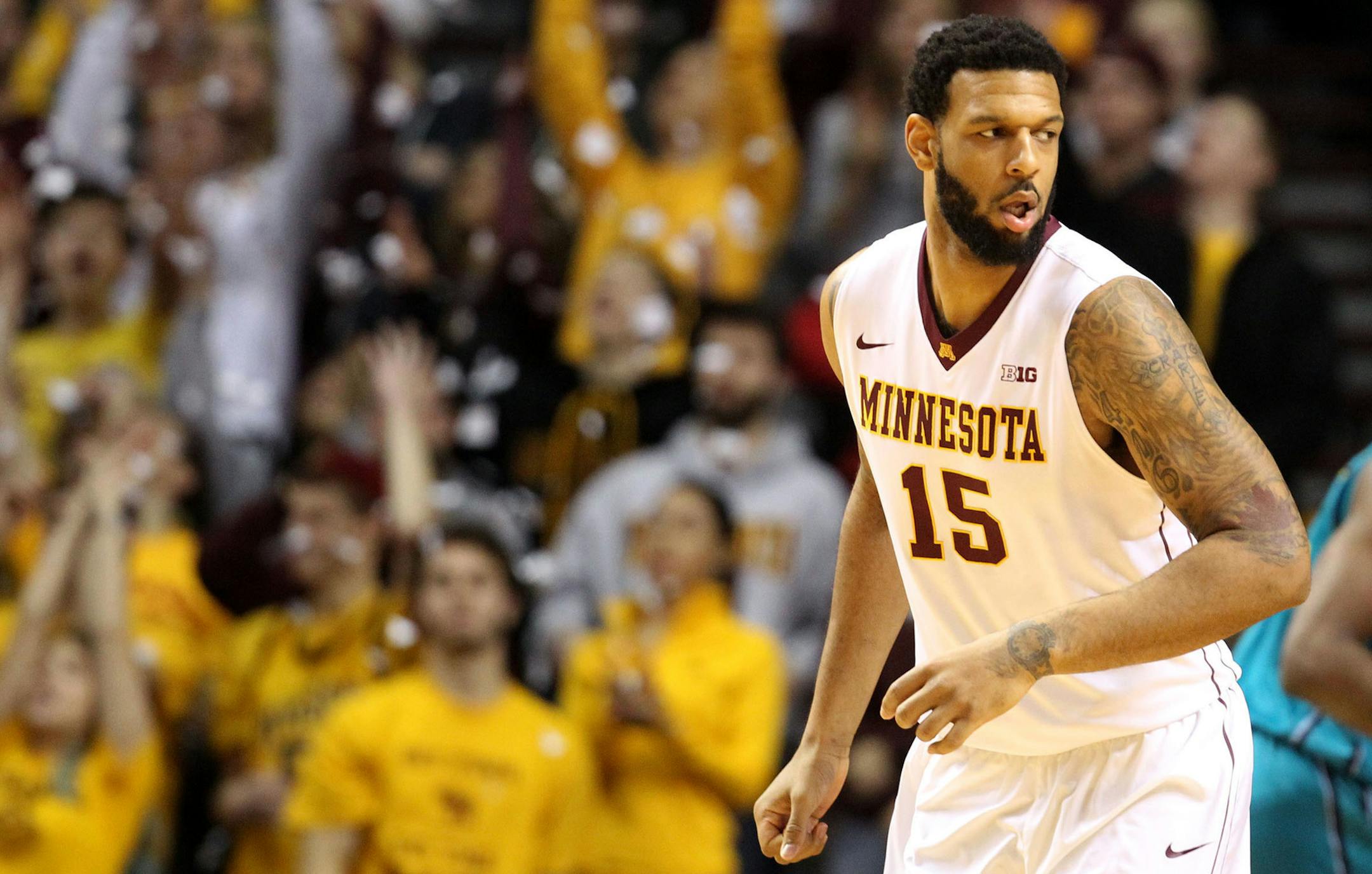 The University of Minnesota's Maurice Walker (15) hits the Gophers first basket as fans launch confetti versus UNC Wilmington during the first half Saturday, Dec. 27, 2014 at Williams Arena in Minneapolis, MN.](DAVID JOLES/ STARTRIBUNE)djoles@startribune.com The University of Minnesota versus UNC Wilmington Saturday, Dec. 27, 2014 at Williams Arena in Minneapolis, MN.